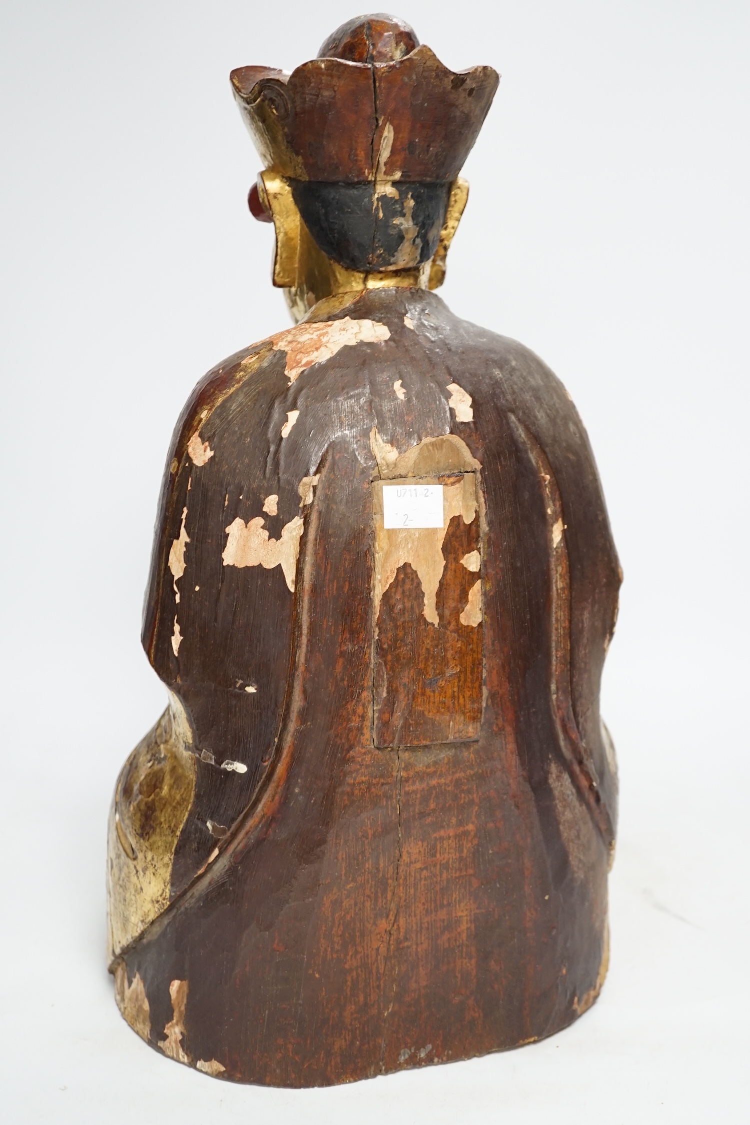 A Chinese gilt lacquered wooden figure of Buddha, possibly Yuan to Ming, 42cm high. Condition - poor to fair, losses to lacquer overall
